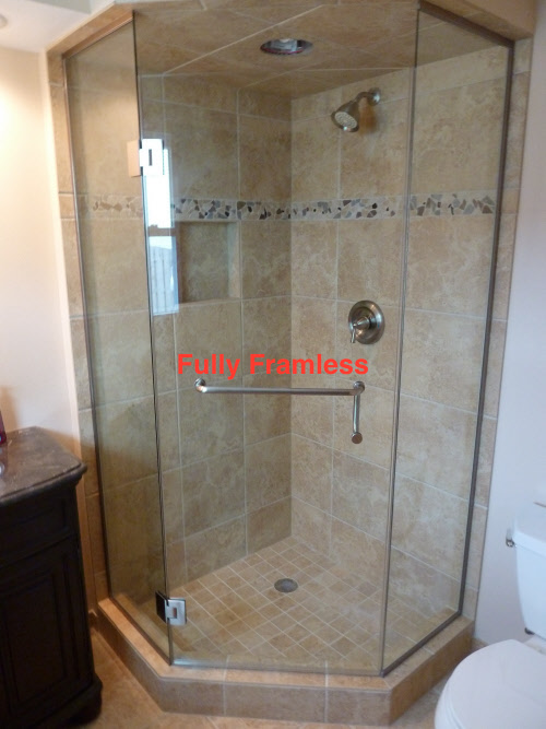 A bathroom with a neo angle shower design featuring a fully frameless glass door.
